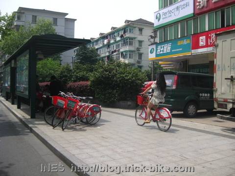 Lady in skirt returning a rental bike