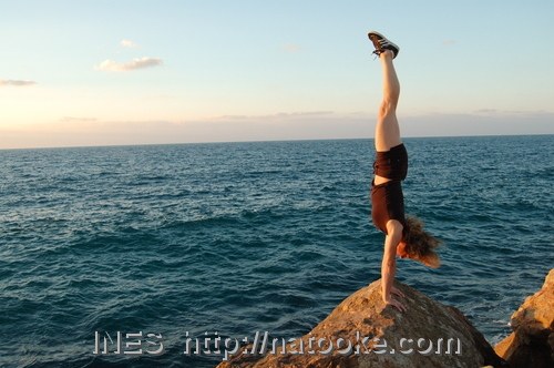 Ines Brunn doing a Handstand on the edge of the Ocean